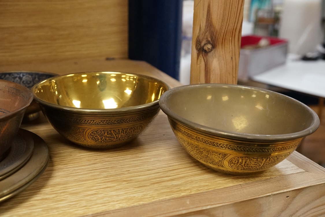 A group of Islamic and Indian brass bowls, largest 15cm in diameter